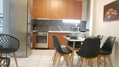 a kitchen with a table and chairs and a refrigerator at Palette Apartment Carmine - Athens Center, 6 BD, 3 BATH in Athens
