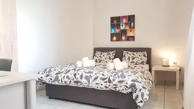a bedroom with a bed with a black and white comforter at Palette Apartment Alice Blue - Athens Center, 3 BD, 2 BATH in Athens
