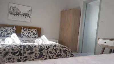 a bedroom with a bed with a black and white comforter at Palette Apartment Alice Blue - Athens Center, 3 BD, 2 BATH in Athens