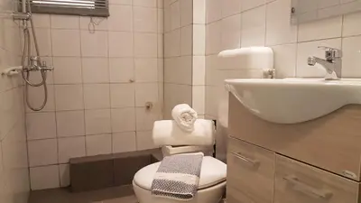 a bathroom with a toilet and a sink at Palette Apartment Alice Blue - Athens Center, 3 BD, 2 BATH in Athens