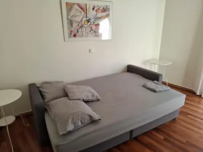 a bed in a room with two tables at Velvendou 36A Apartment in Athens