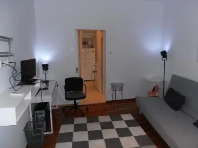 a living room with a couch and a table and a chair at Velvendou 36A Apartment in Athens