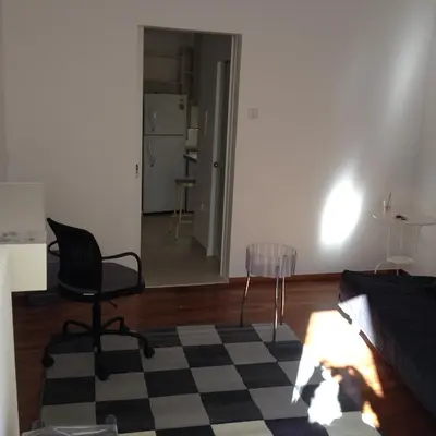 a living room with a black and white checkered floor at Velvendou 36A Apartment in Athens