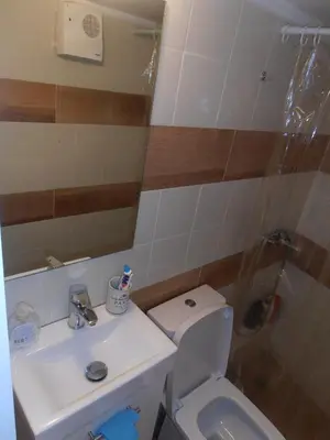 a bathroom with a toilet and a sink and a shower at Velvendou 36A Apartment in Athens
