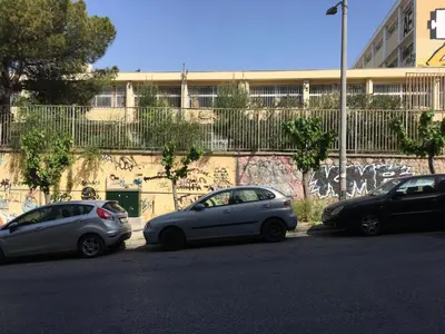 three cars parked in front of a wall with graffiti at Velvendou 36A Apartment in Athens