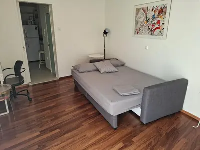 a bedroom with a bed and a table and a chair at Velvendou 36A Apartment in Athens