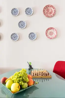 a table with a plate of fruit and a chessboard at Beautiful appartment under Akropolis! in Athens
