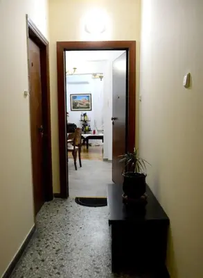 a hallway with a door leading to a living room at Athens Apartment in Athens