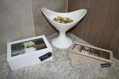 a white vase and two boxes on a table at Athens Apartment in Athens