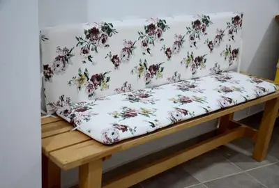 a cushioned bench with a floral pattern on a wall at Athens Apartment in Athens
