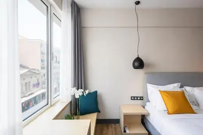 a bedroom with a bed and a window at St. Bjur Suites in Athens