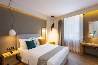a hotel room with a large bed and a window at St. Bjur Suites in Athens