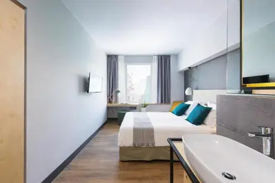 a hotel room with a bed and a sink at St. Bjur Suites in Athens