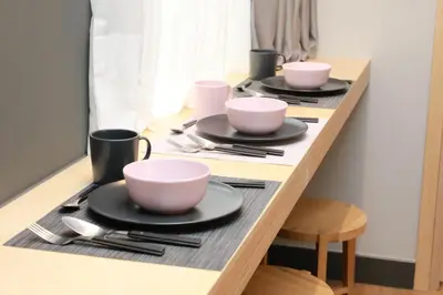 a table with three cups and plates and utensils at St. Bjur Suites in Athens