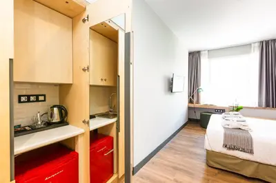 a small room with a bed and a kitchen at St. Bjur Suites in Athens