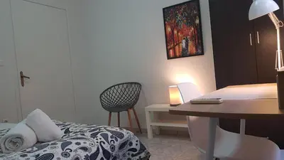 a bedroom with a bed and a desk with a desk at Palette Apartment Bamboo - Athens Center, 6 BD, 3 BATH in Athens