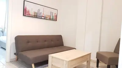 a living room with a couch and a table at Palette Apartment Bamboo - Athens Center, 6 BD, 3 BATH in Athens