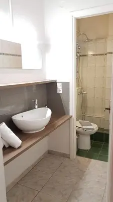 a bathroom with a sink and a toilet at Palette Apartment Bamboo - Athens Center, 6 BD, 3 BATH in Athens