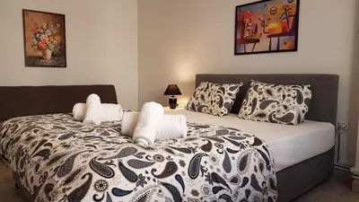 a bedroom with a black and white bed with pillows at Palette Apartment Chocolate - Athens Center, 6 BD, 3 BATH in Athens