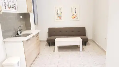 a small kitchen with a couch and a table at Palette Apartment Chocolate - Athens Center, 6 BD, 3 BATH in Athens