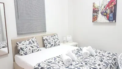 a bedroom with a bed with white and blue pillows at Palette Apartment Chocolate - Athens Center, 6 BD, 3 BATH in Athens