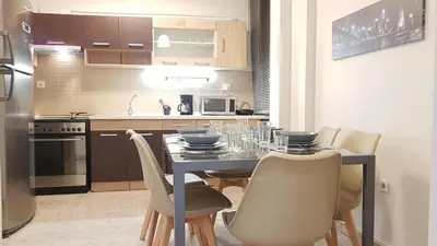 a kitchen with a dining room table with chairs at Palette Apartment Chocolate - Athens Center, 6 BD, 3 BATH in Athens