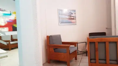 a room with chairs and a table and a picture on the wall at Palette Apartment Chocolate - Athens Center, 6 BD, 3 BATH in Athens