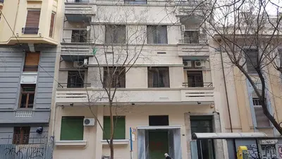 a tall building with windows and a bus in front of it at Palette Apartment Chocolate - Athens Center, 6 BD, 3 BATH in Athens