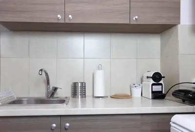a kitchen counter with a sink and a paper towel at Cozy Studio in the center of Athens in Athens