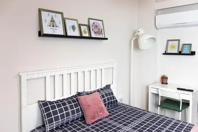 a bedroom with a blue and white bed and a desk at Cozy Studio in the center of Athens in Athens