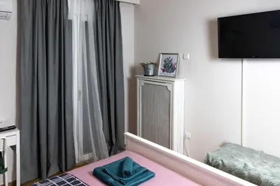 a hotel room with a bed and a television at Cozy Studio in the center of Athens in Athens