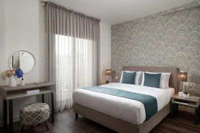 a bedroom with a bed and a large window at Urban Nest - Suites & Apartments in Athens