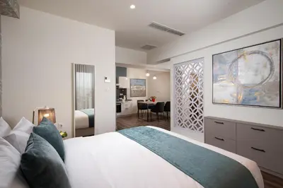 a bedroom with a bed and a living room at Urban Nest - Suites & Apartments in Athens