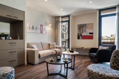 a living room with a couch and two tables at Urban Nest - Suites & Apartments in Athens