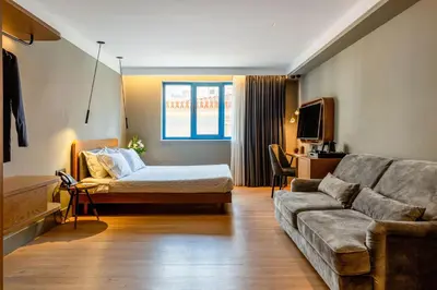 a living room with a bed and a couch at Bob W Athens Eolou in Athens