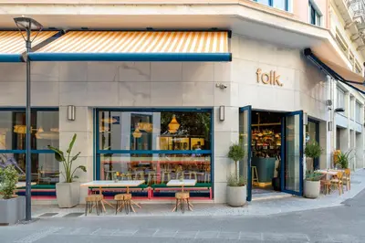 a restaurant with tables and chairs in front of a store at Bob W Athens Eolou in Athens