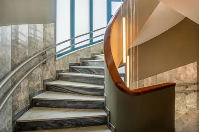a spiral staircase in a building with a circular stair case at Bob W Athens Eolou in Athens
