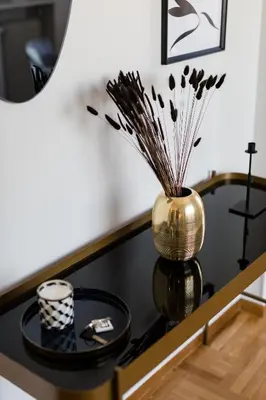 a table with a vase on it with a mirror at Elegant Luminous 3BD apartment in Kolonaki by UPSTREET in Athens