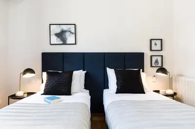 two beds sitting next to each other in a room at Elegant Luminous 3BD apartment in Kolonaki by UPSTREET in Athens