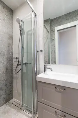 a bathroom with a glass shower and a sink at Elegant Luminous 3BD apartment in Kolonaki by UPSTREET in Athens