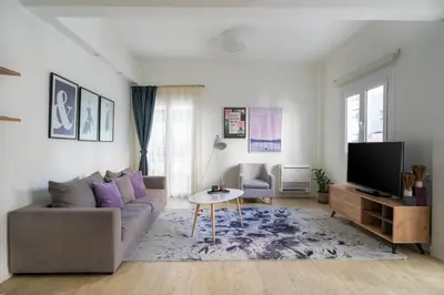a living room with a couch and a tv at Morum Athens Urban Stay in Athens