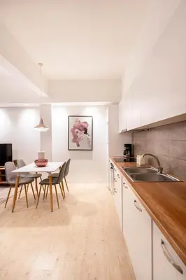 a kitchen and dining room with a table and chairs at Morum Athens Urban Stay in Athens
