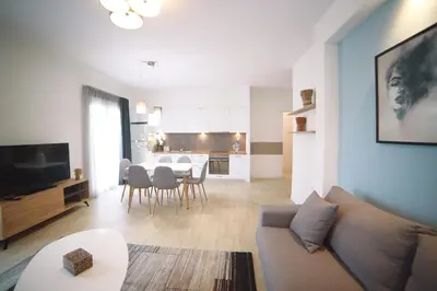 a living room with a couch and a dining room at Morum Athens Urban Stay in Athens