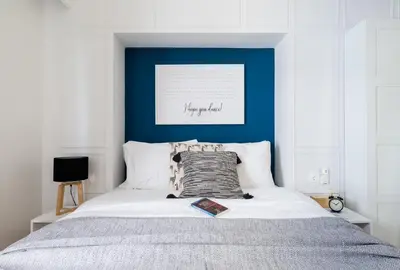 a bedroom with a bed with a blue wall at Desirable 1BD Apartment in Kolonaki by UPSTREET in Athens