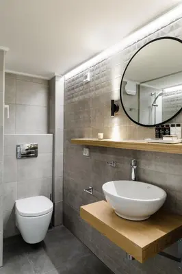 a bathroom with a sink and a toilet and a mirror at Desirable 1BD Apartment in Kolonaki by UPSTREET in Athens