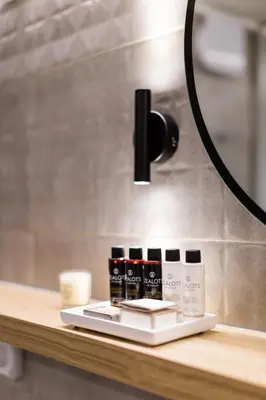 a light on top of a table with cosmetics at Desirable 1BD Apartment in Kolonaki by UPSTREET in Athens
