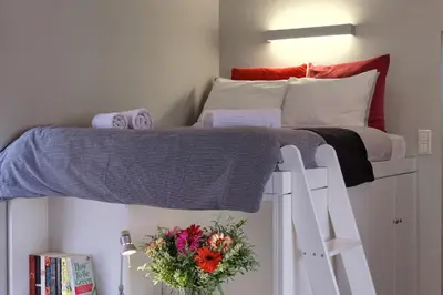 a bedroom with a bunk bed with flowers on it at Homz AH03 Penthouse Studio Hilton Area in Athens