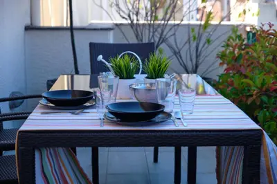 a table with two bowls and glasses on it at Homz AH03 Penthouse Studio Hilton Area in Athens
