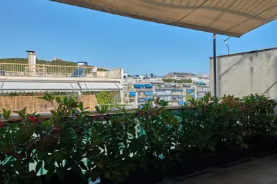 a balcony with plants and a view of a city at Homz AH03 Penthouse Studio Hilton Area in Athens