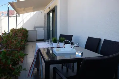 a table on a balcony with chairs and a tableablish at Homz AH03 Penthouse Studio Hilton Area in Athens